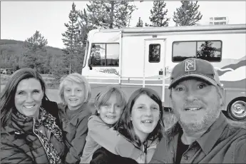  ?? BREAUX WALKER ?? Breaux Walker, right, with his family, from left, Edie Silver Walker, Stokes Walker, Mirakel Walker and Reyne Walker, and their RV Stormy on Sept. 27 along the banks of the Madison River in Yellowston­e National Park.