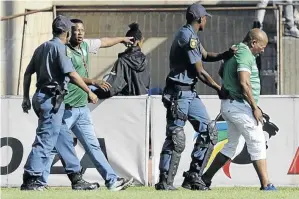  ?? / GALLO IMAGES/ CHARLE LOMBARD ?? Police were called to control unruly Celtic fans who threw missiles before invading the pitch in a match against Cape Town City at the Dr Molemela Stadium on Sunday.