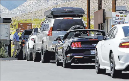  ?? Rachel Aston Las Vegas Review-Journal @rookie__rae ?? The glut of visitation has prompted the Bureau of Land Management to temporaril­y close the 13-mile Scenic Drive loop on days when the parking lots fill up and traffic at the fee gates backs up.
