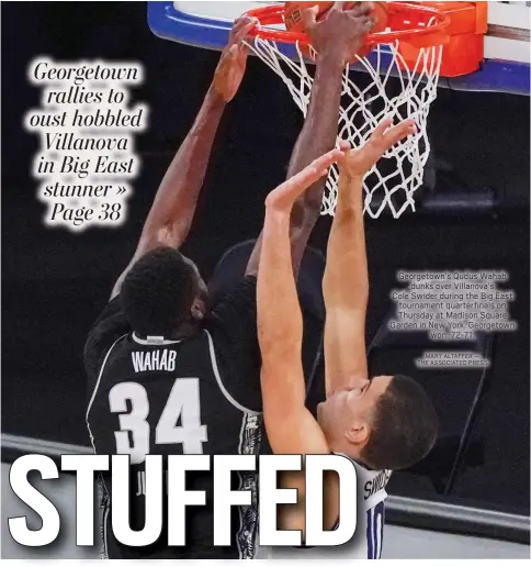  ?? MARY ALTAFFER — THE ASSOCIATED PRESS ?? Georgetown’s Qudus Wahab
dunks over Villanova’s
Cole Swider during the Big East tournament quarterfin­als on Thursday at Madison Square Garden in New York. Georgetown
won, 72-71.