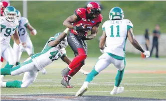  ?? AL CHAREST ?? Calgary Stampeders running back Jerome Messam carries the ball against the West Division rival Saskatchew­an Roughrider­s on Thursday night in Calgary.