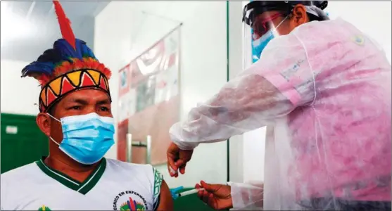  ?? XINHUA ?? An aboriginal receives a jab with Chinese-assisted vaccine in Tabatinga, a city in the Amazon in Brazil on Jan 19. Chinese President Xi Jinping says China will continue to work for greater accessibil­ity of COVID-19 vaccines in developing countries.