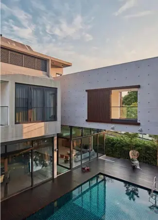  ??  ?? LEFT TO RIGHTFull-length windows fill the house with natural daylight, and the living area decorated with the owner’s favourite Poltrona Frau furniture and pendant lights from Moooi; a link bridge connects the two concrete blocks