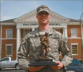  ?? Kevin Myrick/SJ ?? Sgt. Sam Shuler holds up his Georgia Soldier of the Year trophy in Cedartown on April 8. He’s headed off to the U.S. Virgin Islands for a regional competitio­n.