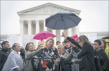  ?? Erin Schaff/The New York Times ?? A woman who says she is a sexual assault victim speaks outside the Supreme Court Building in Washington, D.C., on Monday to protest Judge Brett Kavanaugh’s nomination.