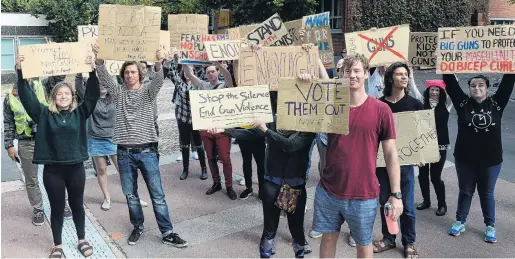  ?? PHOTO: LINDA ROBERTSON ?? Don’t take your guns to town . . . The Dunedin March For Our Lives antigun violence protest gets ready to march on the Octagon on Saturday afternoon.