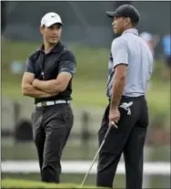  ?? CHRIS O’MEARA — THE ASSOCIATED PRESS ?? Tiger Woods, right, will part with swing coach Chris Como and will embark on his latest comeback without a swing coach, saying he has worked hard to relearn his body and the golf swing.