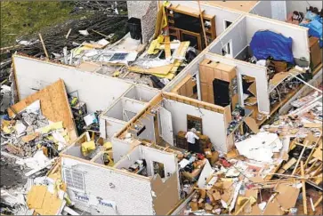  ?? Mark Humphrey Associated Press ?? A WOMAN salvages items from a destroyed home Tuesday near Lebanon, Tenn. The tornadoes that struck after midnight tore apart more than 140 buildings when “many of these folks were sleeping,” one official said.