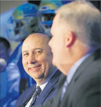  ?? Luis Sinco Los Angeles Times ?? DAN GUERRERO, UCLA’s athletic director, says “there was a spike in both donations and ticket sales” after Chip Kelly was hired as football coach. He is shown with Kelly at a Nov. 27 news conference.