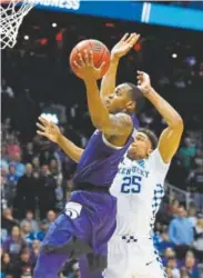  ?? Kevin C. Cox, Getty Images ?? Kansas State’s Barry Brown drives past Kentucky’s PJ Washington for the go-ahead basket late in Thursday night’s game. The Wildcats won.