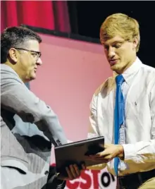  ??  ?? Sports editor Stephen Hargis, left, presents Bradley Central’s Cole Copeland with the Scrappy Moore Male Athlete of the Year award at the banquet. The Scrappy Moore Female Athlete of the Year, Calhoun’s Jana Johns, has enrolled to take classes at South...