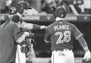  ?? Canadian Press photo ?? Toronto Blue Jays outfielder Steve Pearce (28) is congratula­ted by Blue Jays first baseman Justin Smoak (14) after hitting a three-run home run against the Seattle Mariners during fifth inning American League baseball action in Toronto, Thursday.