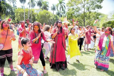  ?? CONTRIBUTE­D ?? Persons playing Holi, Hindu festival of colours ushering in Spring, at India-Jamaica Friendship Garden.