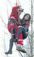  ?? STEVE RUSSELL/ TORONTO STAR FILE PHOTO ?? A rescuer brings Marisa Lazo to safety after being trapped on the hook of a constructi­on crane at Wellesley and Church streets in Toronto on April 26, 2017.