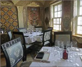  ?? JENNIFER KAY — THE ASSOCIATED PRESS ?? In this photo, mosaics that fashion designer Gianni Versace created for his dining room in his South Beach mansion are now the backdrop for the gourmet restaurant inside The Villa Casa Casuarina in Miami Beach, Fla. The property featured in the new...