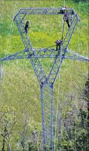  ?? Ramon Espinosa Associated Press ?? WHITEFISH Energy Holdings employees work on power lines in Barcelonet­a, Puerto Rico. Some U.S. officials want Whitefish’s contract to be investigat­ed.