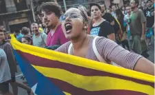  ??  ?? PROTEST: A pro-independen­ce woman demonstrat­es in Barcelona.