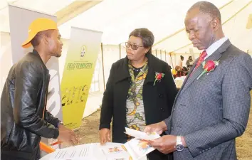  ??  ?? Harare Provincial Affairs Minister Cde Miriam Chikukwa (left) and AFM Harare East province Overseer Amon Chinyemba (right) interact with Empower Bank loan officer Wellington Zvandasara during Empowermen­t Day and Expo in Harare yesterday.