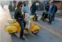  ?? Reuters ?? Members of a Vespa riders’ club gather at sunrise for a ride in Lahore. —
