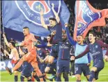  ?? Christophe Archambaul­t / AFP / Getty Images ?? Paris Saint-Germain players celebrate after clinching the French league title in Paris.