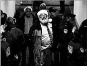  ?? ALEX EDELMAN/GETTY-AFP ?? Capitol Police arrest a demonstrat­or dressed as Santa Claus for participat­ing in a protest against the GOP tax bill.