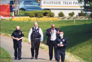  ?? Julio Cortez / Associated Press ?? Police walk near the scene of a shooting at a business park in Frederick, Md., on Tuesday.