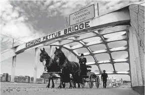  ?? [JOHN BAZEMORE/THE ASSOCIATED PRESS] ?? Lewis’ casket moves over the Edmund Pettus Bridge by horse-drawn carriage Sunday.