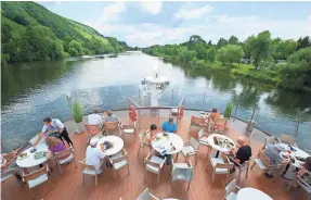  ?? VIKING ?? Guests dine on the terrace of Viking’s Alruna longship. Viking’s target demographi­c is experience­d travelers, ages 50 plus.