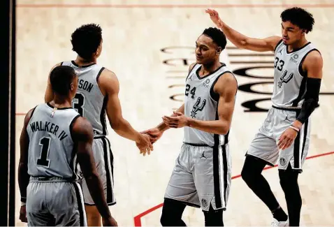  ?? Abbie Parr / Getty Images ?? Former Florida State standout Devin Vassell (24) and ex-Duke star Tre Jones (33) have found common ground as the two rookies on the Spurs’ roster.