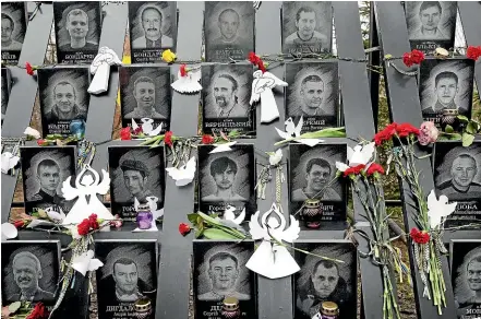  ?? AP ?? Flowers and paper angels decorate a memorial in Kyiv’s Independen­ce Square (Maidan) to people who died during Ukraine’s 2014 revolution, which led to the ongoing conflict with Russia. US President Joe Biden says he is ‘‘convinced’’ that Russian President Vladimir Putin has decided to invade Ukraine, with pro-Russian rebels evacuating civilians from the conflict zone, and tensions spiking along the militarise­d border.