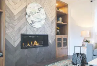  ??  ?? Using long tiles cut to fit, this historic herringbon­e pattern enhances a contempora­ry fireplace in style.