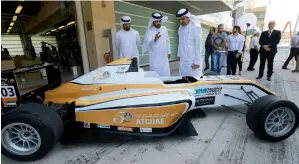  ?? Photo by Ryan Lim ?? Mohamed bin Sulayem (centre) President of ATC UAE, Adef Al Awani, general secretary Abu Dhabi Sports Council and Ahmed Al Kaabi (left) take a close look at the F4 race car during the launch of the Yas Marina Circuit 2016-2017 calendar announced at the...