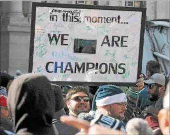  ?? GENE WALSH — DIGITAL FIRST MEDIA ?? A man carries his sign along Broad Street in Philadelph­ia before the start of the Eagles Super Bowl Victory Parade Thursday.