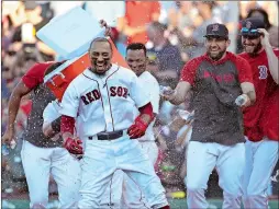  ?? ELISE AMENDOLA/AP PHOTO ?? Mookie Betts of the Boston Red Sox is doused by teammates after drawing a game-ending walk that gave the team a 4-3 win against the Texas Rangers on Wednesday at Fenway Park.