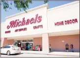  ??  ?? In this file photo, customers lineup outside a Michaels store in Houston. The arts and crafts retailer is going private. (AP)