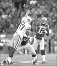  ?? AP/CHARLES KRUPA ?? Patriots quarterbac­k Tom Brady (12) passes over Titans defensive end Karl Klug (97) on Saturday in Foxborough, Mass.