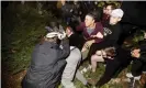  ?? Photograph: Noah Berger/AP ?? A man pushed by protesters is surrounded as he falls to the ground while leaving a speech by Ann Coulter at the University of California, Berkeley, on 20 November.