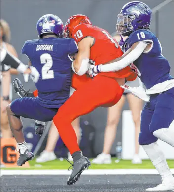  ?? Erik Verduzco
Las Vegas Review-journal ?? Rebels receiver Nick Williams catches a 30-yard touchdown pass in between Wolf Pack cornerback Isaiah Essissima (2) and defensive back Tyriq Mack.