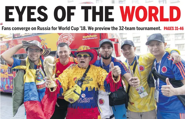  ?? ANTHONY STANLEY/WENN.COM ?? Passionate fans hold a replica of the FIFA World Cup trophy in Moscow in advance of the month-long tournament that kicks off Thursday.