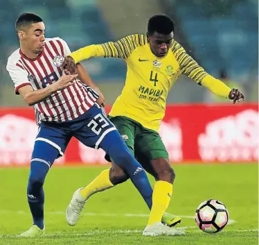  ?? Picture: ANESH DEBIKY/GALLO IMAGES ?? TIGHT TUSSLE: Teboho Mokoena, of SA, and Miguel Almiron, of Paraguay, during their Nelson Mandela Challenge match at the Moses Mabhida Stadium in Durban on Tuesday