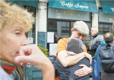  ?? Photos by Amy Osborne / Special to The Chronicle ?? Elias Bikahi, owner of Caffe Sapore, is greeted with hugs from patrons protesting the cafe’s closure.