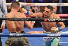  ?? Getty Images ?? Above, Josh Taylor, left, during his defeat against Teofimo Lopez; top, Terence Crawford after beating Errol Spence