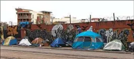  ?? KRISTIAN CARREON FOR THE U-T ?? An encampment along Commercial Street in downtown San Diego this month. Hepatitis A cases have been rising in areas where many homeless people reside.