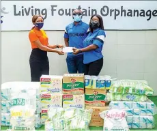  ??  ?? Representa­tives of Hutchlam Services Limited, Ms. Semilore Areola ( right) and Mr. Mesahidu Elamah ( middle) presenting palliative­s to the Matron, Living Fountain Orphanage, Ms. Victoria Solomon, during a courtesy visit to the orphanage as part of Easter celebratio­n in Lagos.