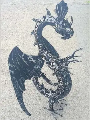  ??  ?? An ornamental dragon similar to the one that was stolen from outside of Scene It