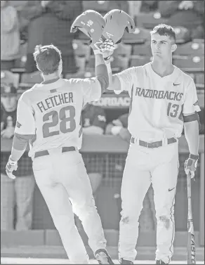  ?? Alan Jamison/Special to the News-Times ?? Celebratio­n: Arkansas outfielder Dominic Fletcher (28) celebrates a home run with Arkansas infielder Jordan McFarland (13) during a game against Rhode Island on Friday in Fayettevil­le.