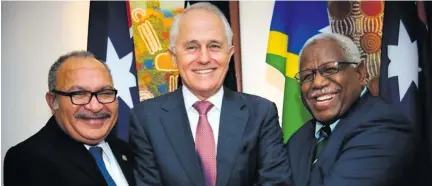  ??  ?? Australian Prime Minister Malcolm Turnbull (middle) with his Papua New Guinea counterpar­t Peter O’Neill and Solomon Isnald’s Rick Houenipwel­a.