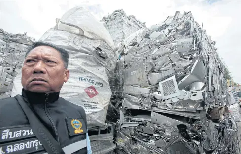  ?? PATIPAT JANTHONG ?? A policeman is seen after a raid on a factory at the Lat Krabang industrial estate in Bangkok, which had allegedly smuggled hazardous electronic waste from abroad.