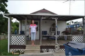  ?? KEITH REYNOLDS — THE MORNING JOURNAL ?? Brenda Rundle, 57, of Wellington, stands on her front porch. Rundle is one of 10 residents suing the owners of the Crestview Mobile Home Park for failure to pay utilities.