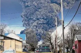  ?? Gene J. Puskar/Associated Press ?? A black plume rises over East Palestine, Ohio, as a result of a controlled detonation of a portion of the derailed Norfolk Southern trains Feb. 6.